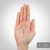 A capsule measuring 0.917 inches (2.329 cm) placed on a hand scale.