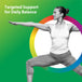 An adult woman practices yoga in a warrior pose indoors.