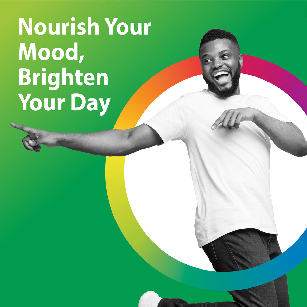 A young Black man is joyfully smiling and laughing while pointing excitedly with both hands.