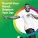 A young Black man is joyfully smiling and laughing while pointing excitedly with both hands.