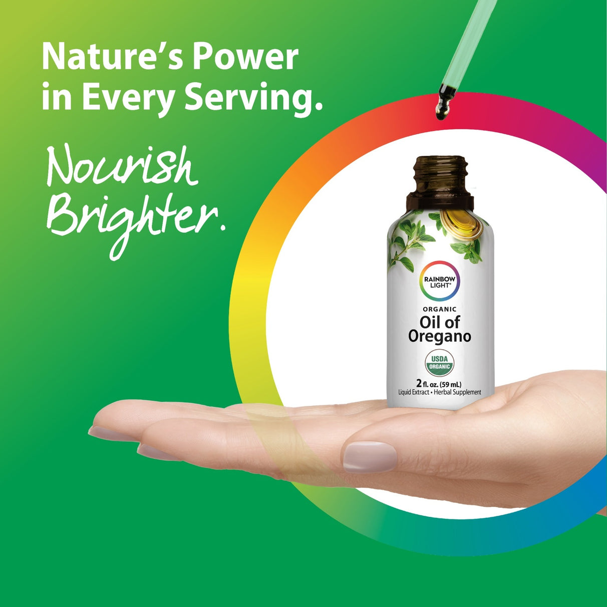 A hand holds a bottle of Organic Oil of Oregano as a dropper releases the liquid.